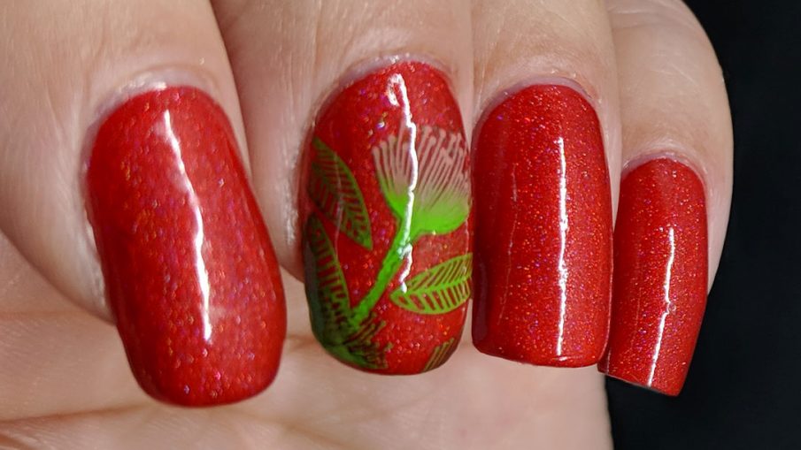 Tomato red nail art with bright green and pink stamped floral and leaf patterns.