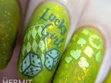 A medium olive/chartreuse nail art with luck, playing cards, dice, and heart/club/spade/diamond stamping decals.