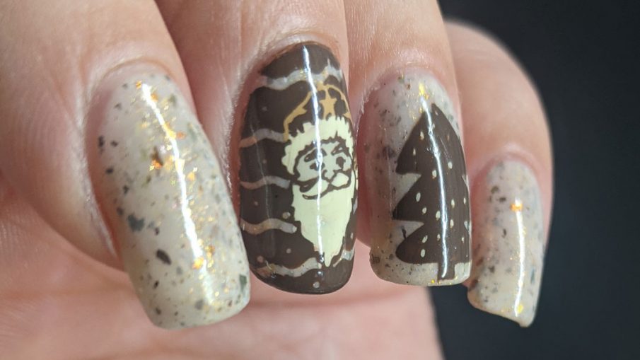 Nail art with Christmas imagery: Santa, Christmas tree, and Santa's sleigh taking off in a shower of stars on a light tan flakie-filled base.