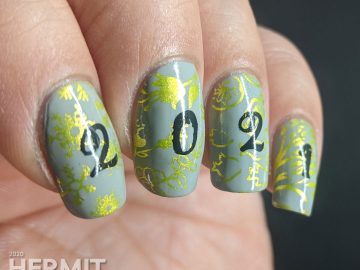 A New Years mani with a grey background, bright green stamping of winter/spring/summer/fall seasons and "2021" on top.
