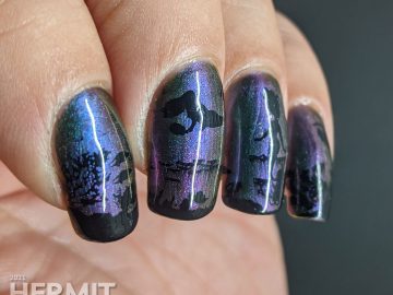 An ultra multichrome base polish from turquoise to purple to orange with ocean floor and swimming mermaids stamped on in black.