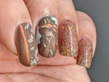 A soft, golden brown art nouveau nail art with a beautiful art nouveau woman, florals, and accompanying sparkly accent nails.
