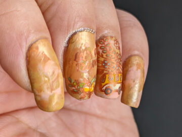 A soft orange smoosh mani with cute bus and camera stamping decals with plants growing out of and around them.