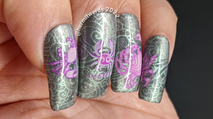 A sterling silver magnetic (zodiac) cancer nail art w/reverse stamping decals of crabs and a swirly ocean/shell background pattern.