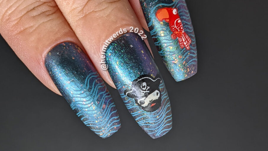 Talk Like a Pirate Day nail art with cute pirate stamping images (captain, ship, parrot) on a teal to purple multichrome polish.
