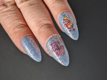 Cute little winter bird nail art with stamping decals of birds in hats and scarves on an extra glitzy blue nail polish