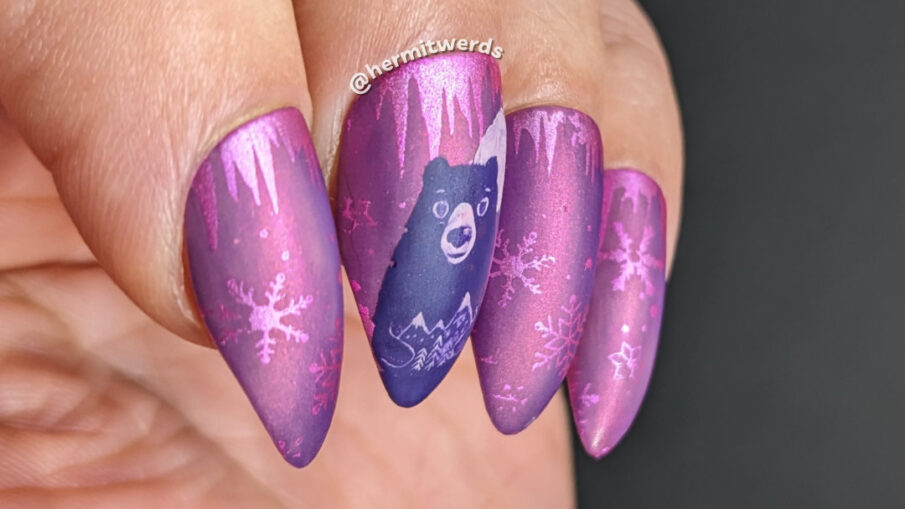 Bear Moon nail art to celebrate the full moon in February on a gorgeous magenta nail polish and snowflakes and icicles in the background.