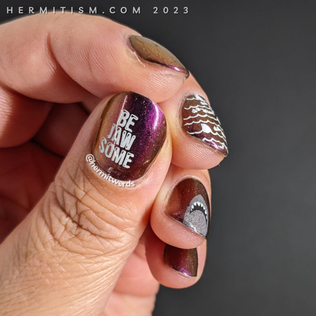 Shark nail art on a dark purple to pink to orange to green ultrachrome with Jaws da-dum shark nail stamping. Jaws movie nails for Shark Week.
