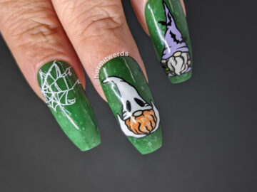 Spooky gnome nail art with spider webs and three gnomes dressed as a bat-loving witch, a ghost, and a cobweb covered spider lover.