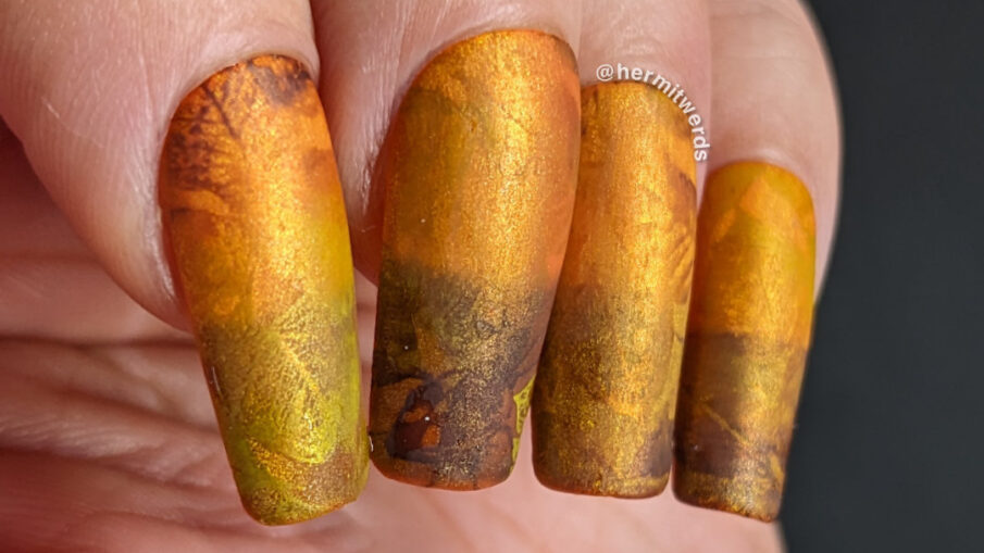 A golden, orange, and brown magnetic mani of fall leaves gently blending into each other for a soft, abstract look. + one bastard stink bug.