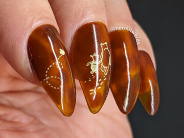 Sheer tortoiseshell nails painted with jelly polishes in mustard and browns with some vintage Pooh and Piglet line art stamped on top.