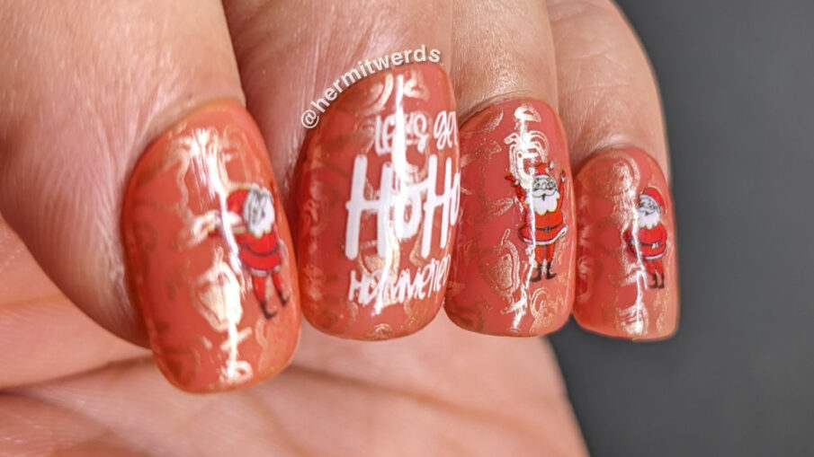 A pink boozy ho ho hammered nail art with wacky-acting Santas who may have had a little too much eggnog while getting ready for Christmas.