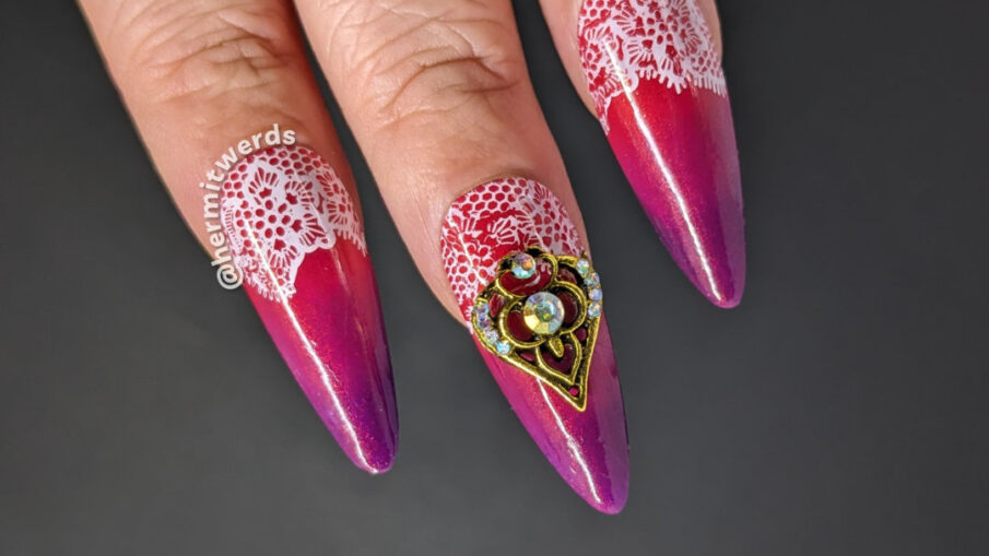 Lace half moon nail art embellished w/bronze, rhinestone-studded nail charms on a purple (cold) to hot pink (warm) thermal. Flipside hearts.