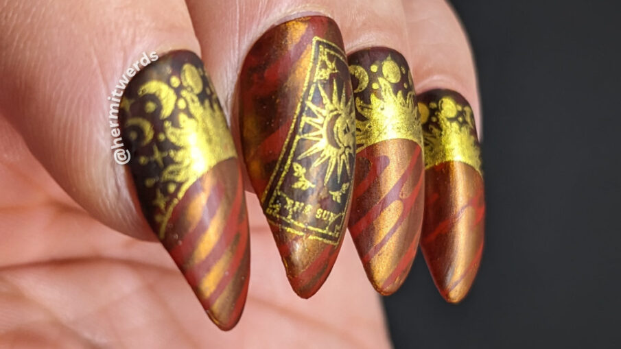 A tarot card mani featuring The Sun card using a space-esque stripped background, sun and moon cycle half moons and golden tarot cards.